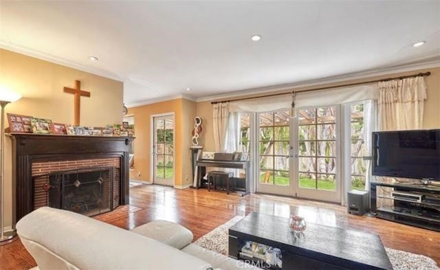 living room with crown molding, french doors, and light hardwood / wood-style floors