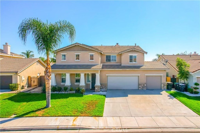 view of front of home featuring a garage and a front lawn