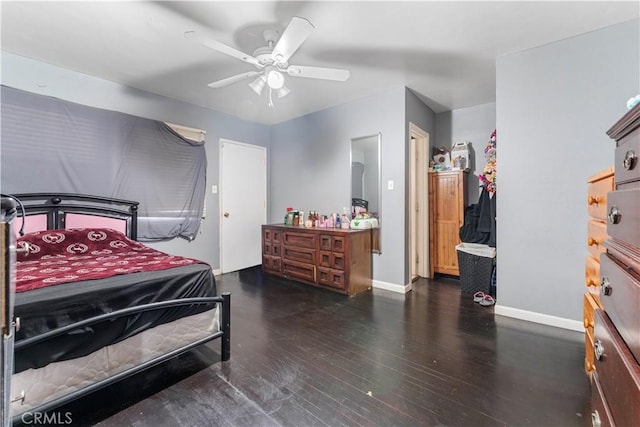 bedroom with dark hardwood / wood-style floors, ceiling fan, and ensuite bathroom