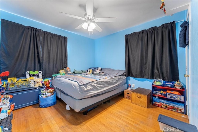 bedroom featuring ceiling fan and wood-type flooring