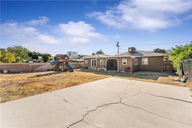 ranch-style house featuring a patio area, a playground, and central AC