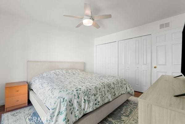 bedroom with hardwood / wood-style floors and ceiling fan