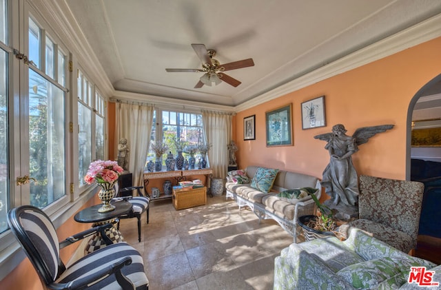 living room featuring ceiling fan and crown molding