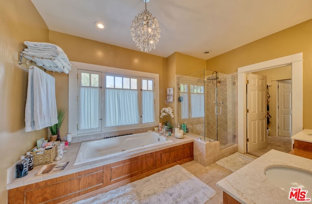 bathroom featuring tile patterned floors, a shower with door, vanity, and a chandelier