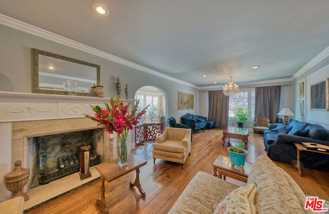 living room featuring light hardwood / wood-style flooring, plenty of natural light, and crown molding