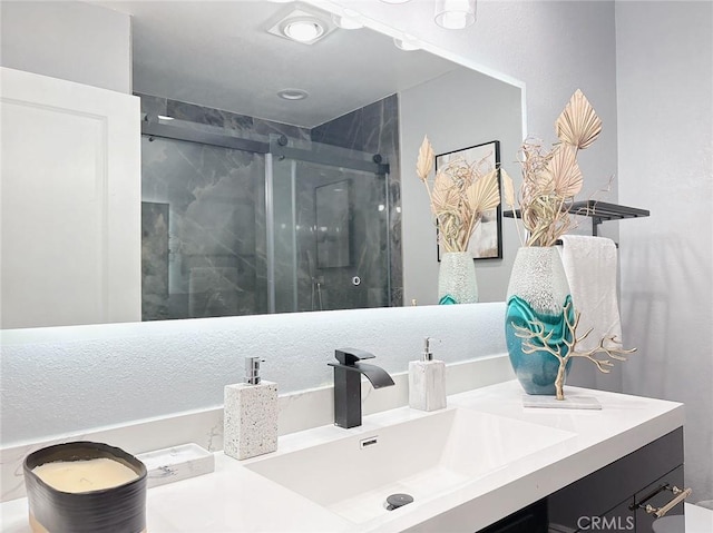 bathroom featuring vanity and a shower stall