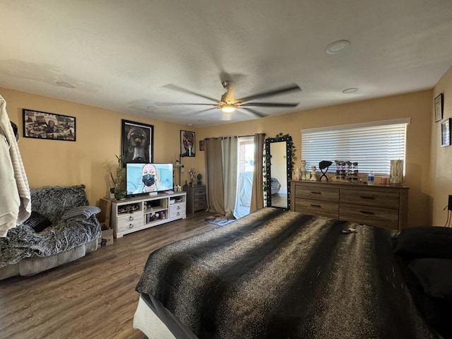 bedroom featuring ceiling fan and dark wood-type flooring