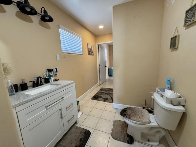 bathroom featuring tile patterned floors, vanity, and toilet