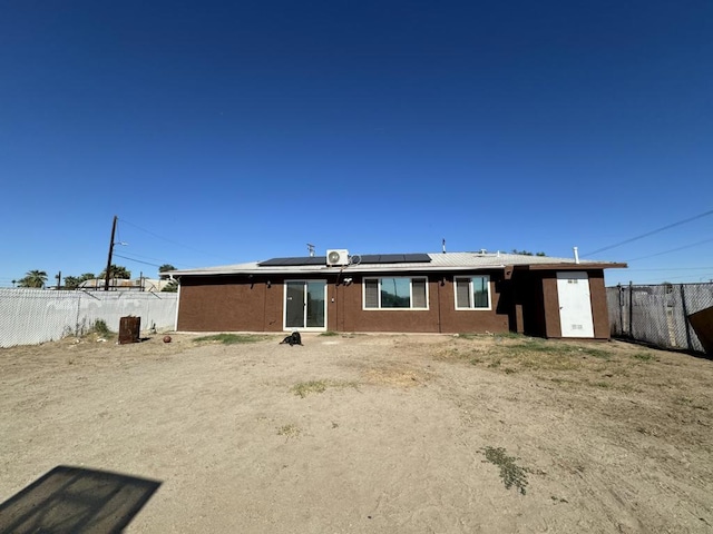 back of property with solar panels