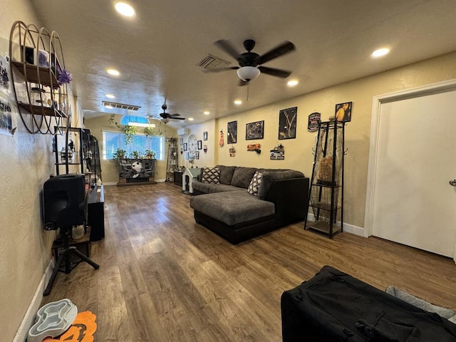 living room featuring ceiling fan and wood-type flooring