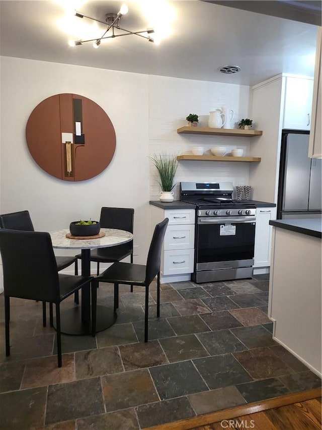 kitchen with white cabinets and appliances with stainless steel finishes