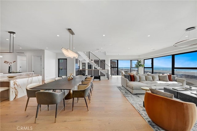 dining room with a water view and light wood-type flooring