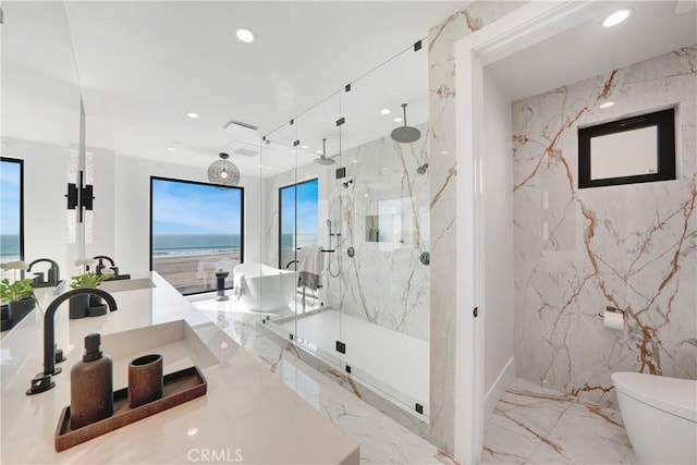 bathroom featuring a water view, an enclosed shower, sink, and toilet