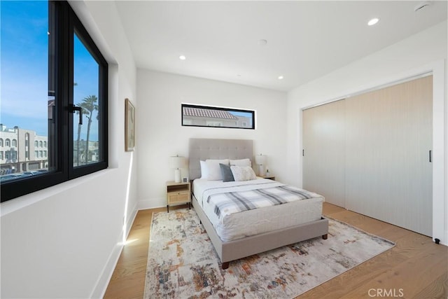 bedroom featuring light hardwood / wood-style floors and a closet