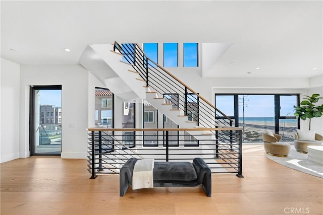 staircase featuring a water view and hardwood / wood-style flooring