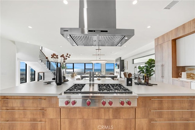 kitchen with a large island, stainless steel gas cooktop, and island range hood