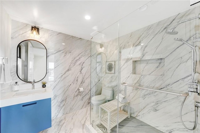 bathroom with toilet, an enclosed shower, and vanity