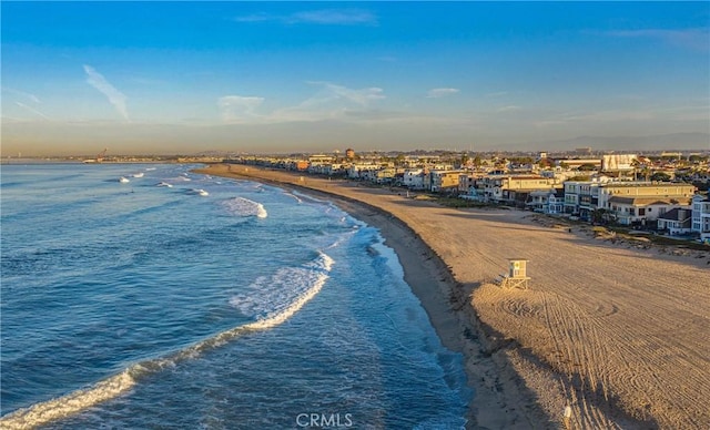 drone / aerial view with a beach view and a water view