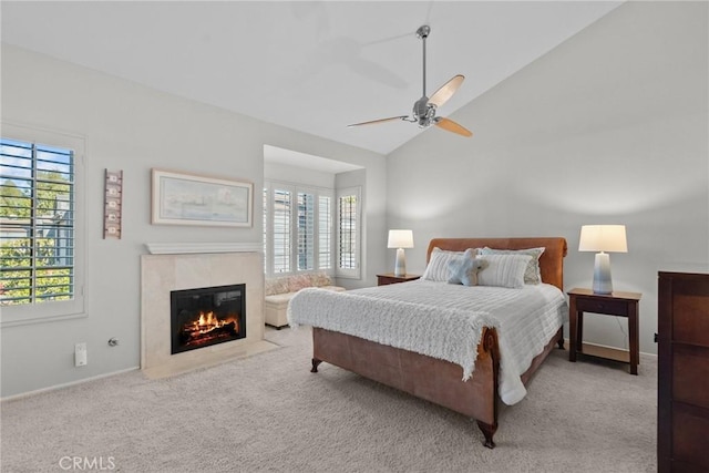 bedroom featuring light carpet, high vaulted ceiling, multiple windows, and ceiling fan