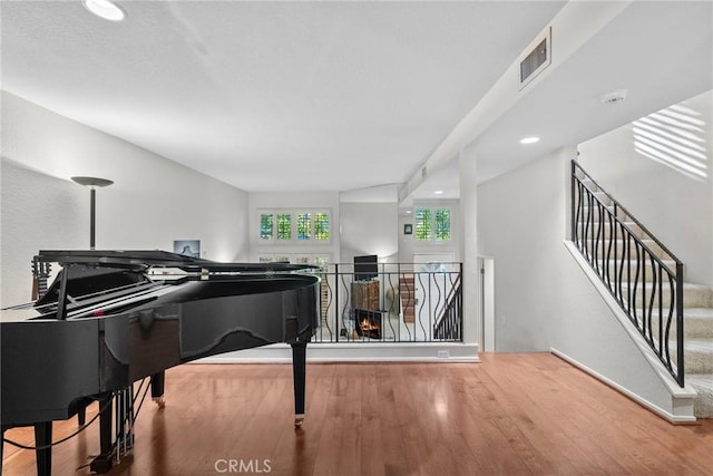 miscellaneous room with hardwood / wood-style floors and a textured ceiling