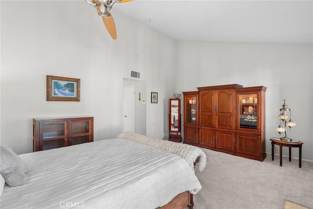 carpeted bedroom with high vaulted ceiling and ceiling fan