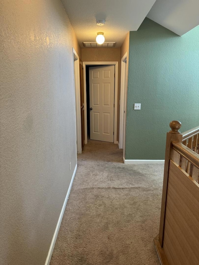 hall with light colored carpet