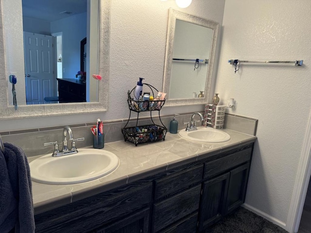 bathroom with vanity and tasteful backsplash