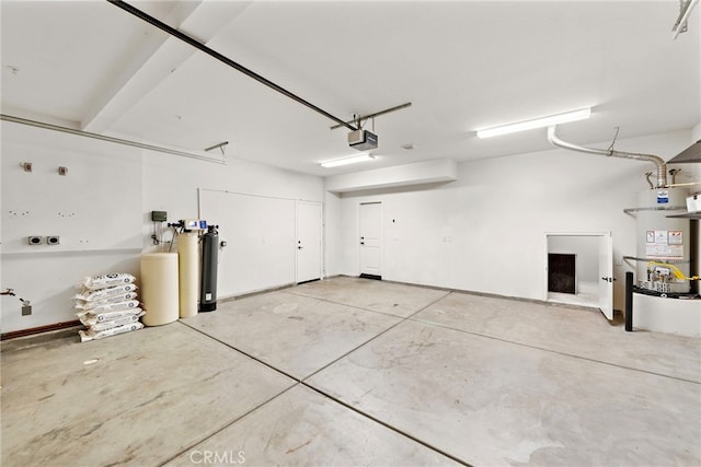 garage featuring water heater and a garage door opener