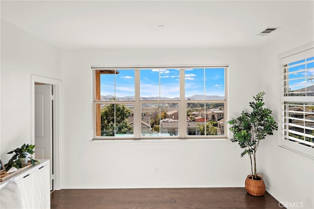 empty room with dark hardwood / wood-style floors