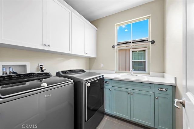 laundry area featuring washer and clothes dryer, sink, and cabinets