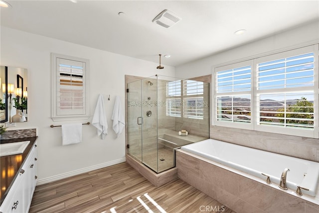 bathroom featuring vanity, hardwood / wood-style flooring, and independent shower and bath