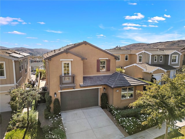 view of front facade featuring a mountain view and a garage