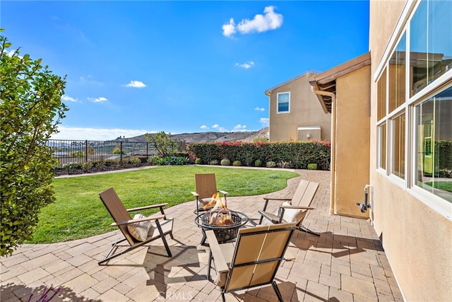 view of patio / terrace featuring a mountain view and an outdoor fire pit