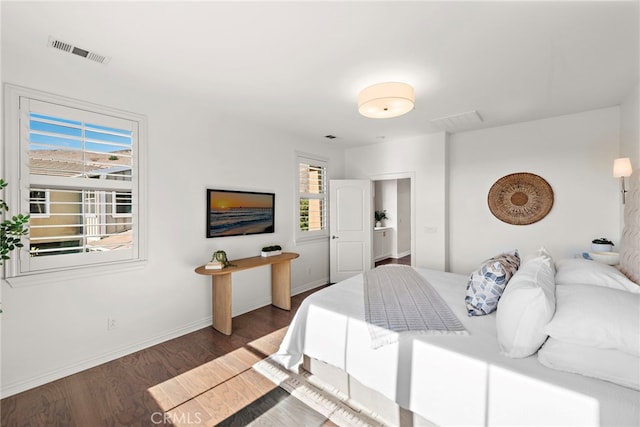 bedroom with dark hardwood / wood-style floors