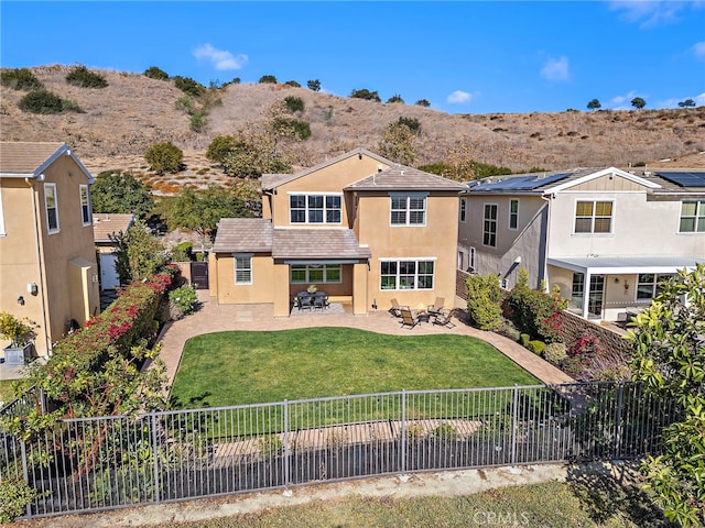 view of front of home with a patio area and a front lawn