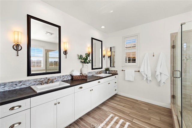 bathroom with vanity, an enclosed shower, and hardwood / wood-style flooring