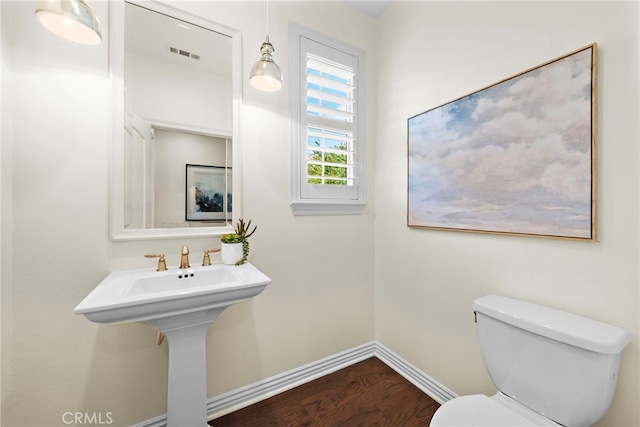 bathroom featuring sink, wood-type flooring, and toilet