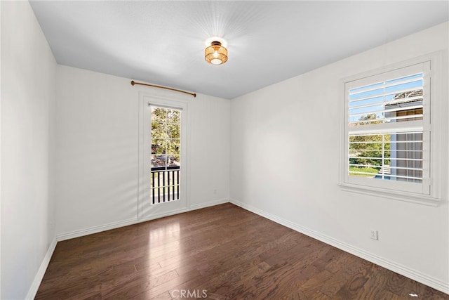 spare room with dark hardwood / wood-style floors