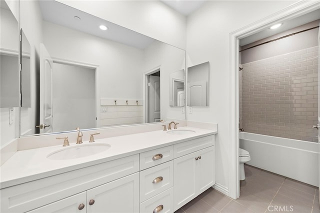 full bathroom featuring tile patterned flooring, vanity, toilet, and tiled shower / bath combo