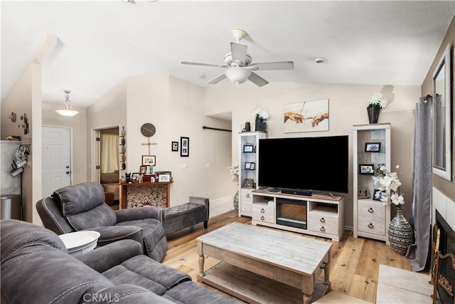 living room with ceiling fan, light hardwood / wood-style flooring, and lofted ceiling