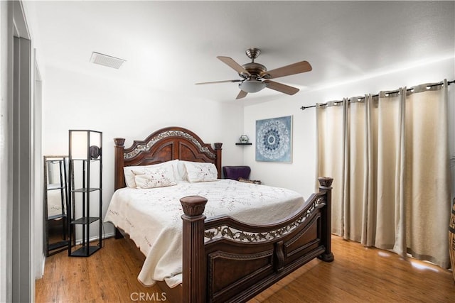 bedroom with ceiling fan and hardwood / wood-style flooring