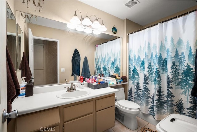 bathroom with tile patterned flooring, vanity, and toilet