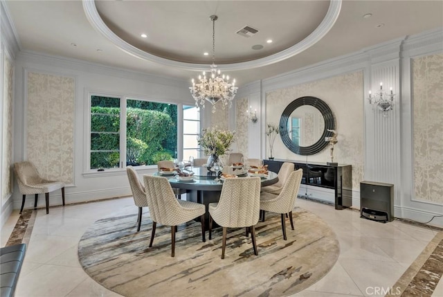 dining area with a notable chandelier, a raised ceiling, and ornamental molding