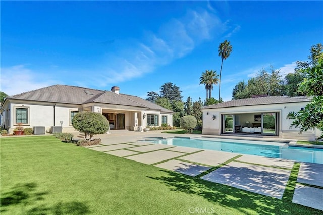 view of swimming pool featuring central AC unit, a patio area, and a lawn