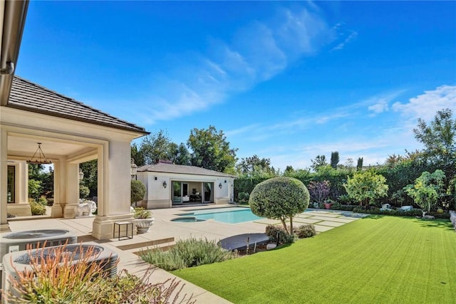 view of swimming pool with a lawn and a patio