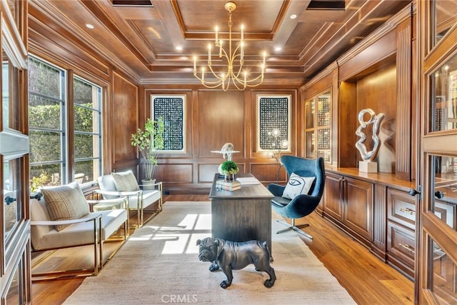 office featuring a chandelier, light wood-type flooring, ornamental molding, and wood walls