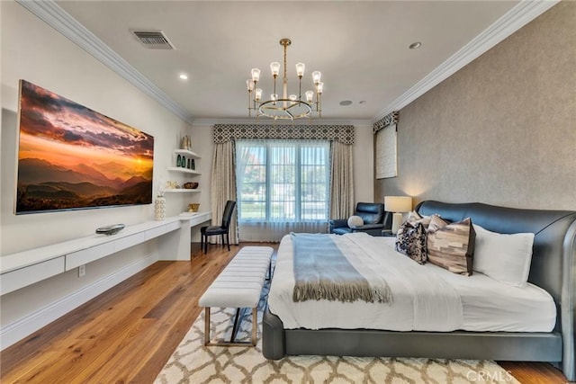 bedroom with a notable chandelier, light hardwood / wood-style floors, and ornamental molding