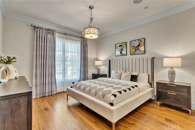 bedroom featuring crown molding and light wood-type flooring