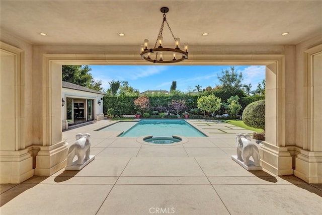 view of pool with an in ground hot tub and a patio