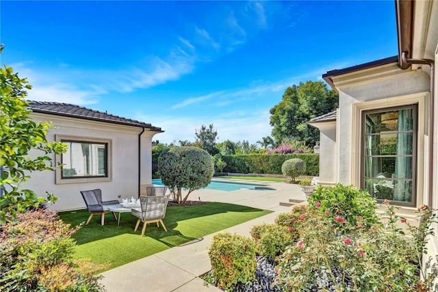 view of pool with a yard and a patio